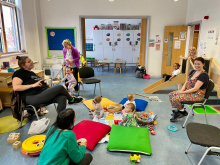 Image shows mum and babies at group, talking and babies playing 
